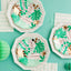 Hexagonal paper plates with green leaf patterns on a teal background