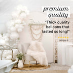 Decorative setup with white balloons, chair, and macrame wall hanging in a room.