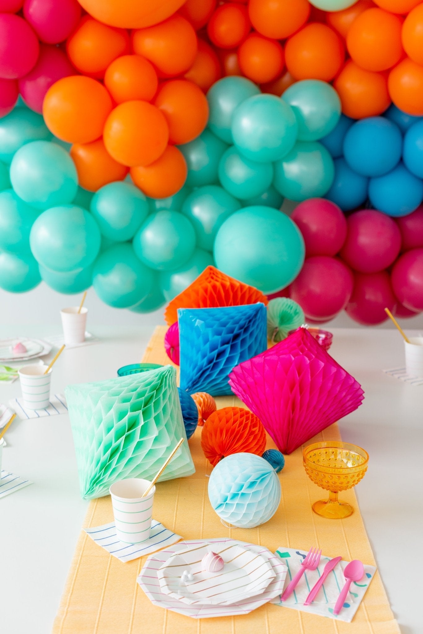Colorful balloon arch with party decorations on a table