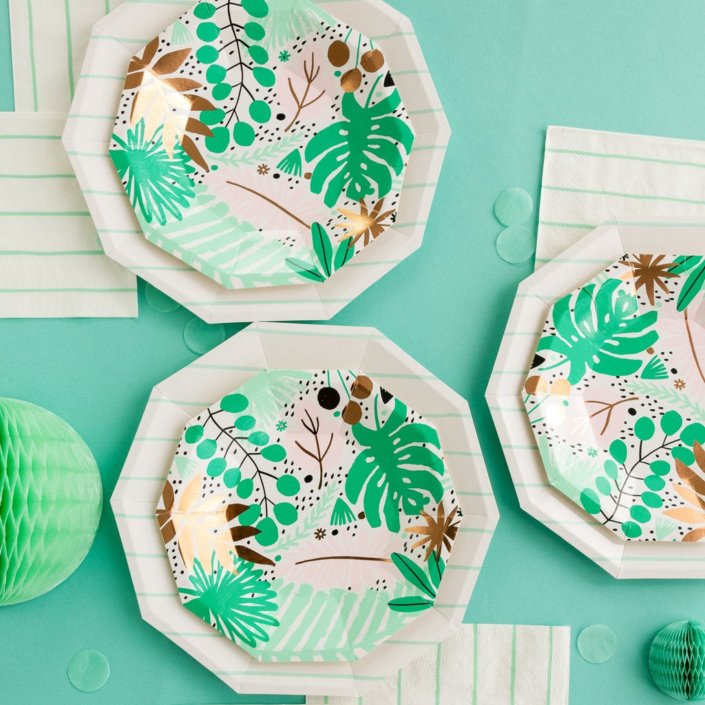 Hexagonal paper plates with green leaf patterns on a teal background