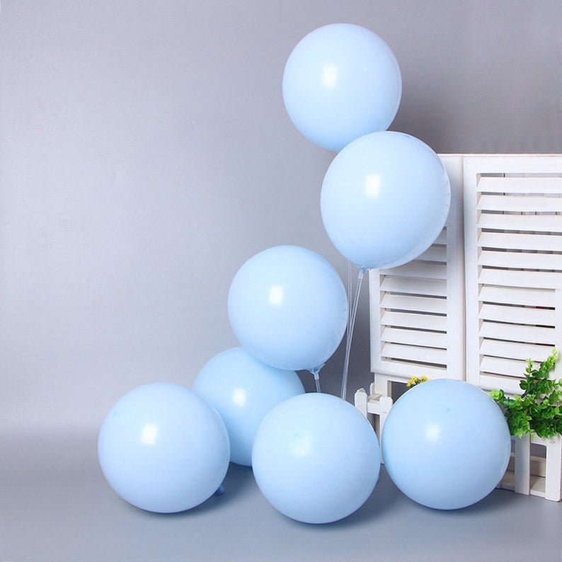 Light blue balloons arranged in a cluster on a neutral background