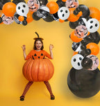Child in a pumpkin costume with Halloween-themed balloons on a yellow background