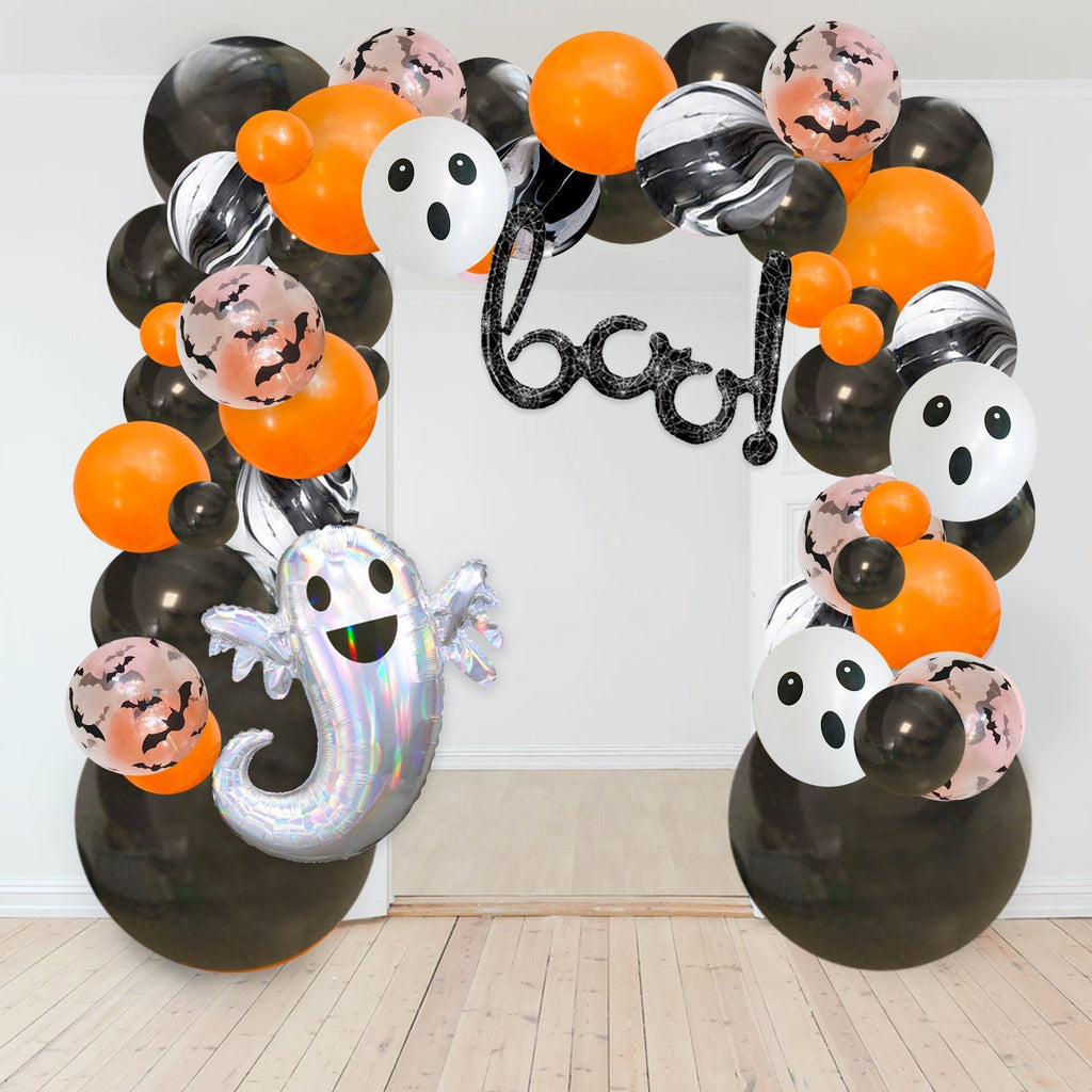 Halloween-themed balloon arch with ghost and ghostly face balloons on a white background.