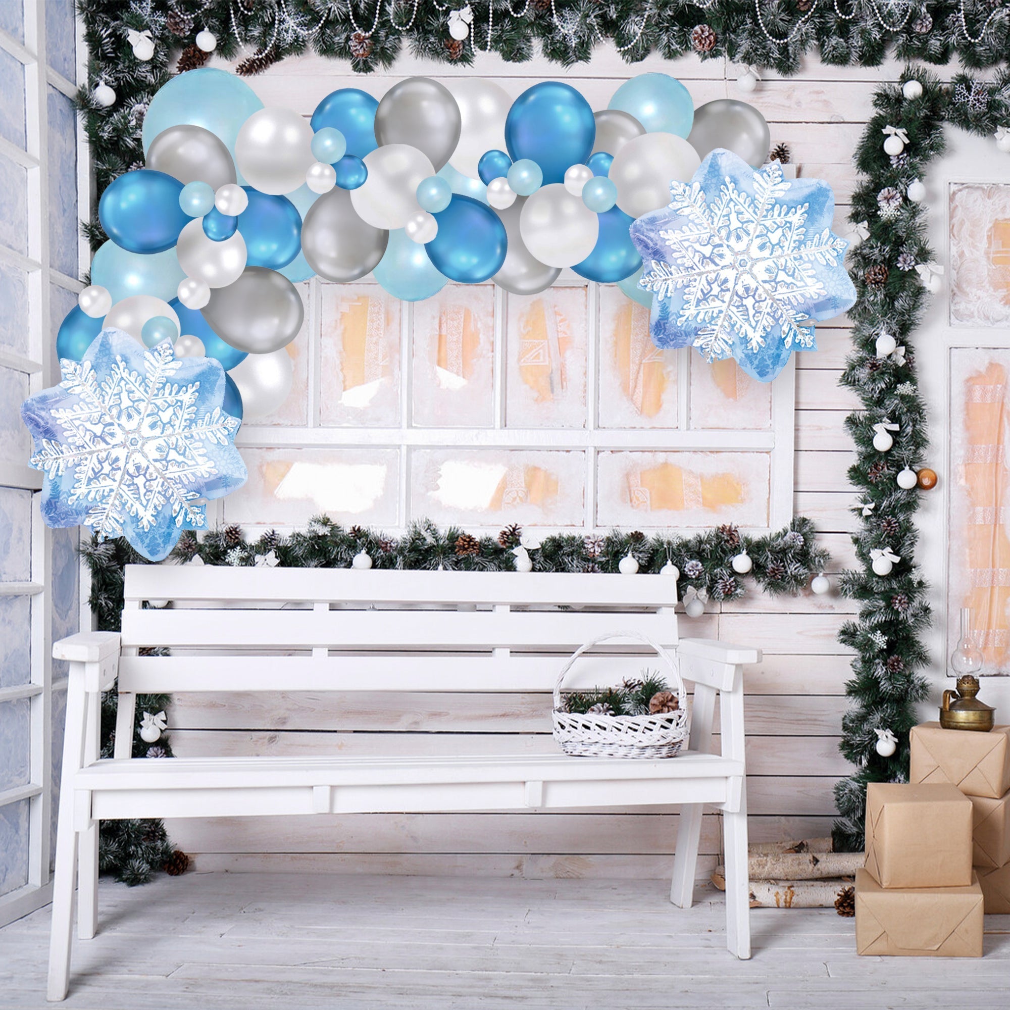 Decorative setup with balloons, snowflakes, and a bench in a festive setting.