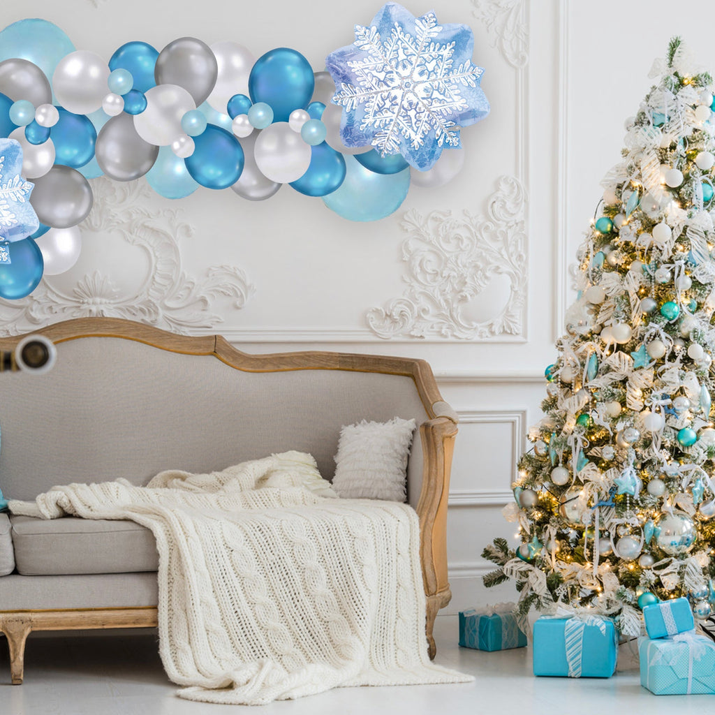 Decorated living room with Christmas tree, balloons, and presents.