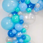 Balloon arch with blue, green, and white balloons on a white background