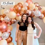 Two women standing in front of a large balloon arch with '15-foot' text above.