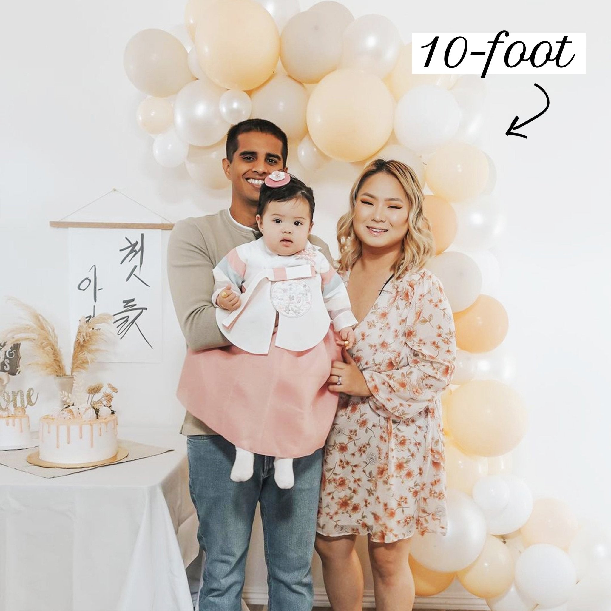 Family with a baby in front of a 10-foot Balloon Garland 