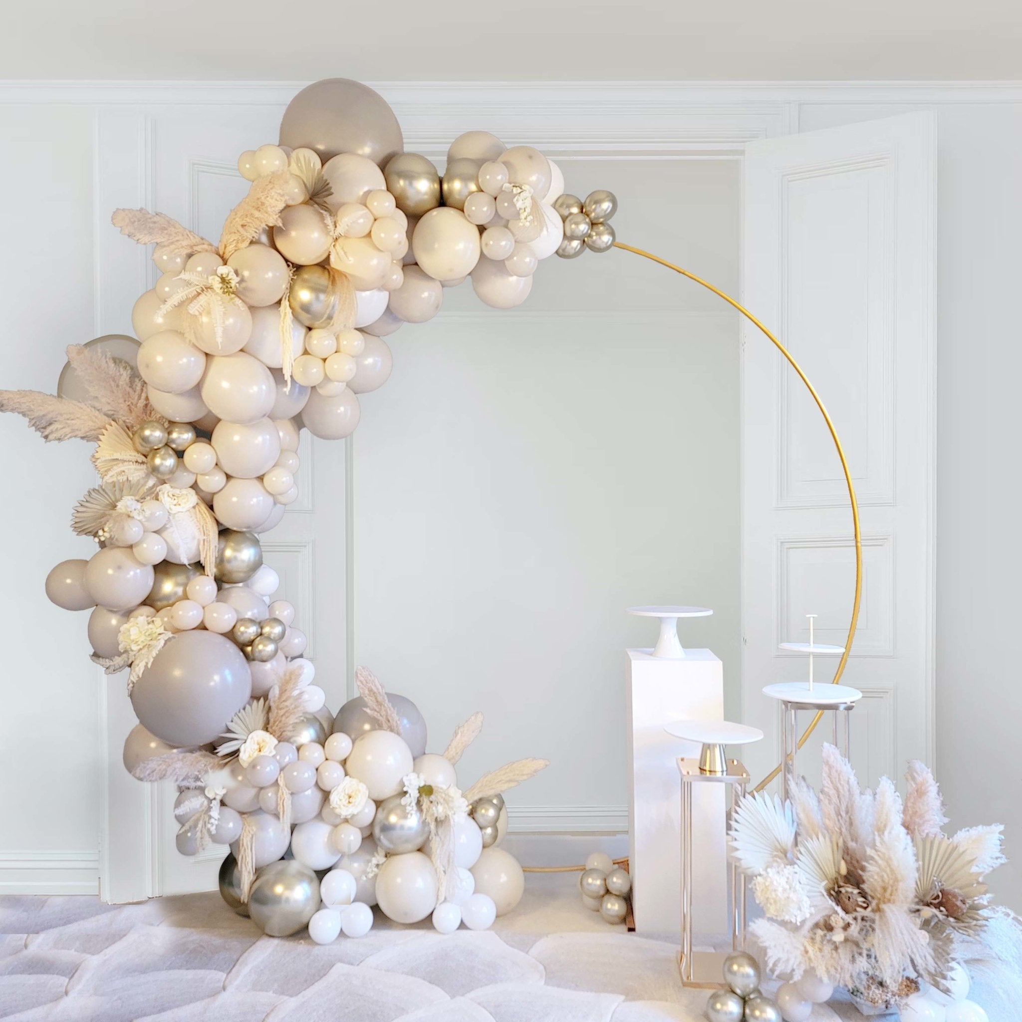 Decorative balloon arch with candles and flowers in a room setting Main image