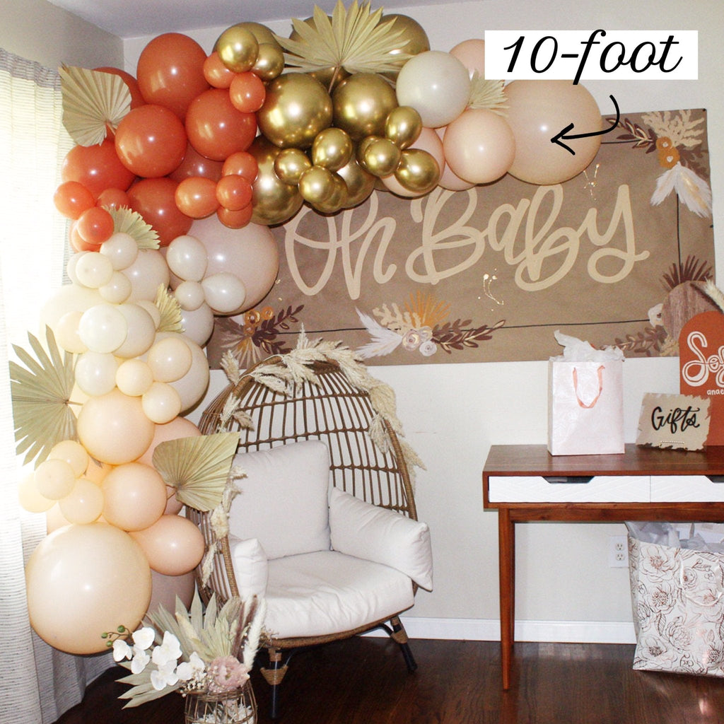 Balloon arch with 'Oh Baby' sign in a room setting