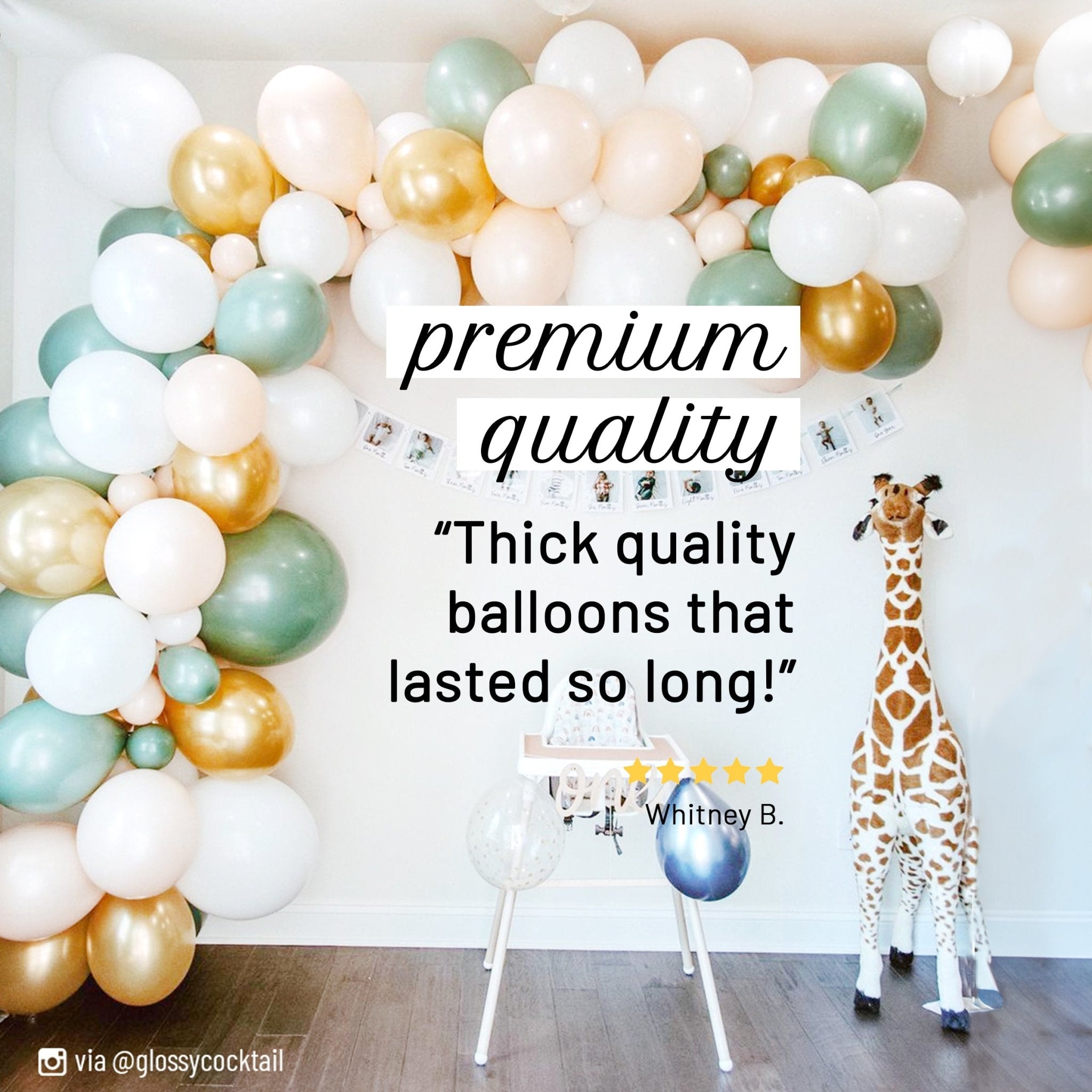 Balloon arch with colorful balloons and a giraffe toy in a room. Main image