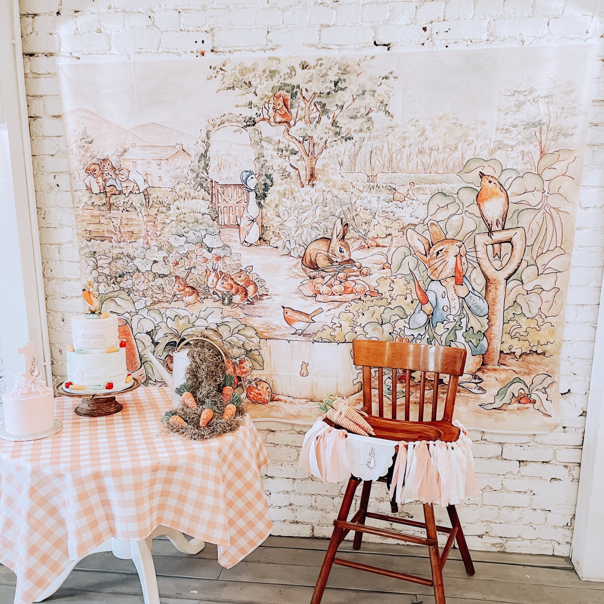 Room with a Peter Rabbit photo backdrop mural of animals and a wooden chair.
