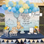 Decorated table with balloons, flowers, and a Winnie the Pooh-themed backdrop.