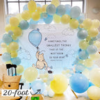 Balloon arch with Winnie the Pooh and balloons, featuring a quote.