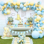 Decorated outdoor space with Winnie the Pooh theme, balloons, and floral arrangements.