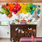 Decorated room with colorful balloons, a cactus balloon, and festive decorations.