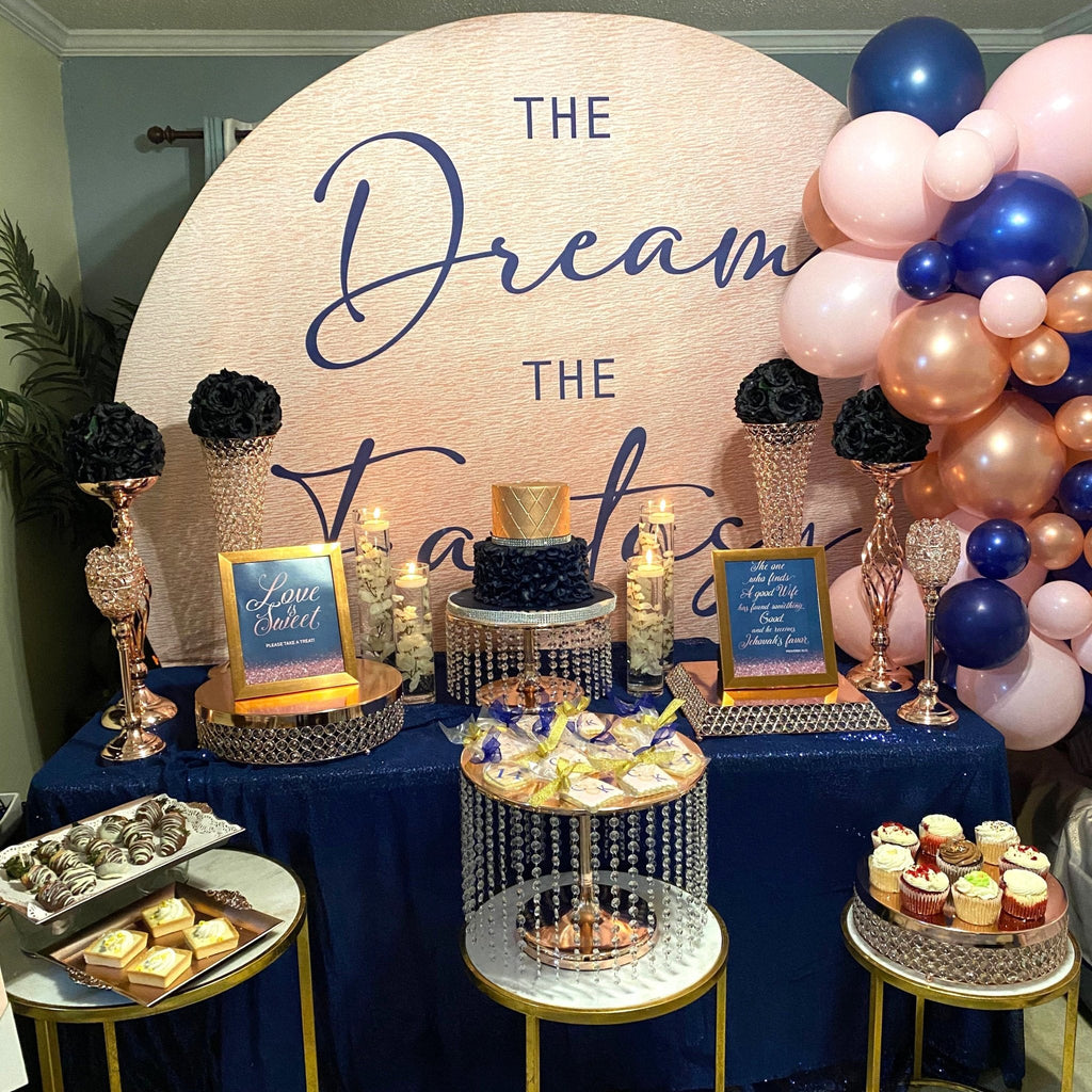 Decorative dessert table with balloons and 'The Dream Table' sign