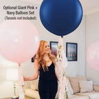 Woman holding pink and navy balloons in a living room setting