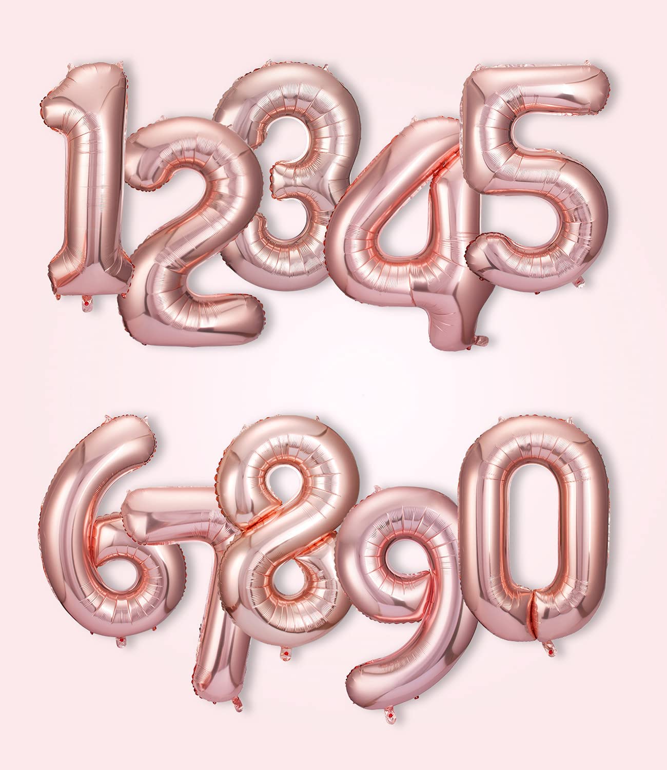Rose gold number balloons on a white background