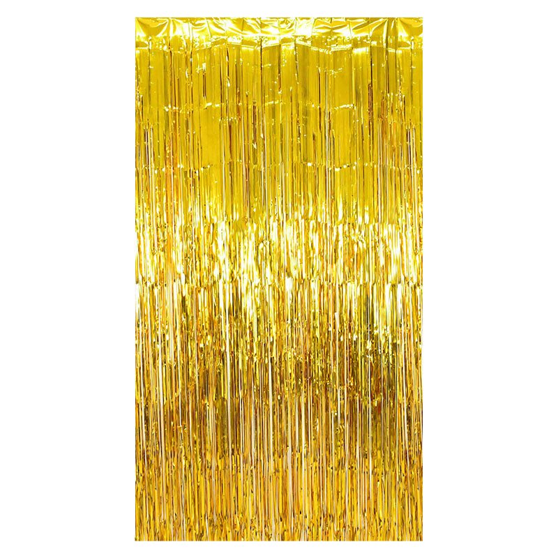 Gold metallic fringe tinsel curtain backdrop on a white background