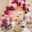 Decorated birthday party with balloons, cake, and sweets in a room.