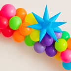 Colorful balloon arch with a blue star-shaped balloon on a light background