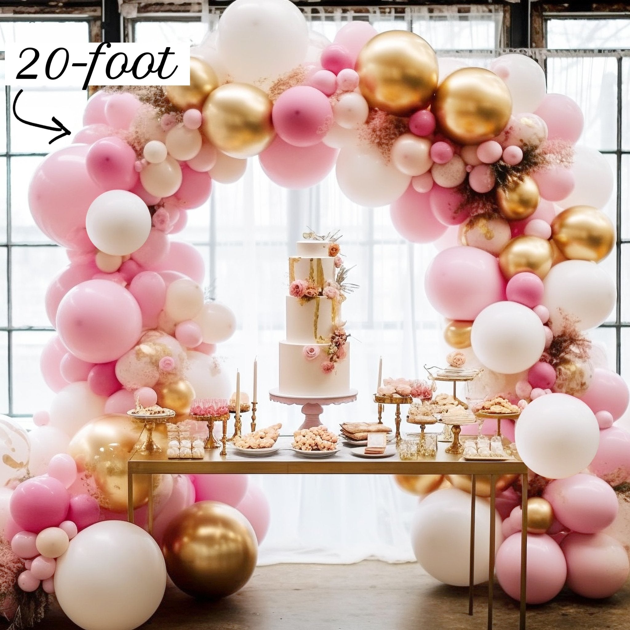 Balloon arch with pink, gold, and white balloons above a dessert table.