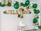Decorative balloon arch with 'Wild One' balloons in a room setting.